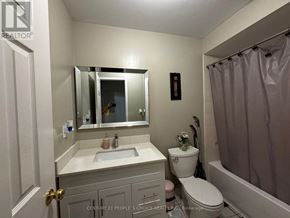 Mississauga (Meadowvale Village) townhouse for rent - A bathroom with a sink, toilet, and a mirror.