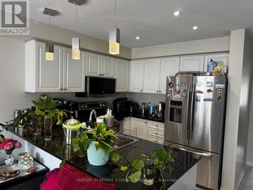Mississauga (Meadowvale Village) townhouse for rent - A kitchen with a black granite counter top and stainless steel appliances.