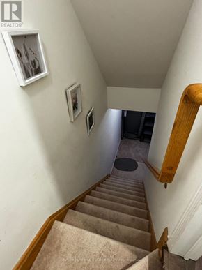 Mississauga (Meadowvale Village) townhouse for rent - A staircase with beige carpet and wooden handrails.