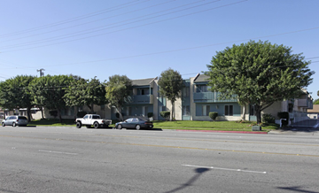 Anaheim apartment for rent - A street view with cars and a building in the background.