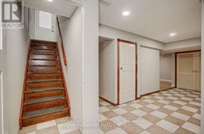 Vaughan (Maple) house for rent - A hallway with a checkered floor and a wooden staircase.