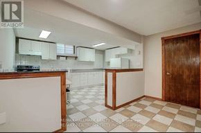 Vaughan (Maple) house for rent - A kitchen with white cabinets and a checkered floor.