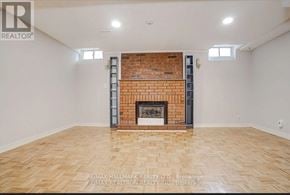 Vaughan (Maple) house for rent - A large empty room with a fireplace and wooden flooring.