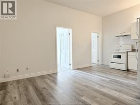 Windsor apartment for rent - A spacious living room with a kitchen area in the background.