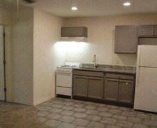 San Antonio apartment for rent - A kitchen with a white refrigerator and a white dishwasher.