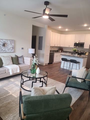 Washington apartment for rent - A living room with a green chair and a white couch.