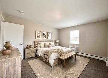 Morrisville apartment for rent - A living room with a grey sofa and a television.