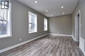 Hamilton house for rent - A room with grey walls and wooden flooring.