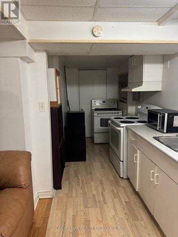 Brampton (Fletcher's Creek Village) house for rent - A kitchen with white cabinets and a wooden floor.