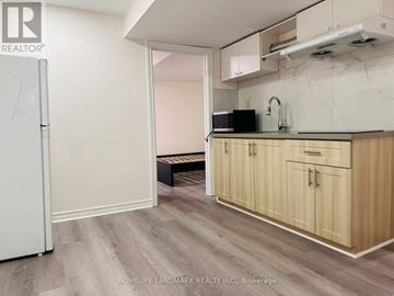 Markham (Milliken Mills West) house for rent - A kitchen with wooden cabinets and a white refrigerator.