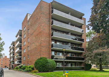 Windsor apartment for rent - A tall apartment building with balconies on the upper floors.