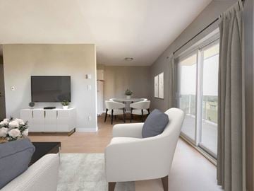 Windsor apartment for rent - A living room with a grey sofa and a white chair.
