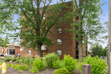 Windsor apartment for rent - A brick building with a tree in front of it.