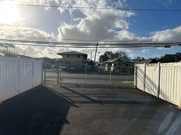 Wahiawa apartment for rent - A white fence with a gate in the middle of a road.