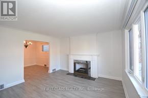 Toronto (Bedford Park-Nortown) house for rent - A room with a fireplace and a chandelier.