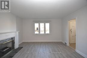 Toronto (Bedford Park-Nortown) house for rent - A room with a fireplace and a door is shown.
