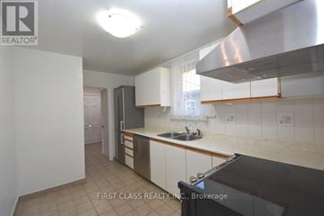 Toronto (Bedford Park-Nortown) house for rent - A kitchen with a sink and a stove top oven.