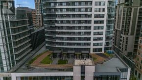 Hamilton (Central) condo for rent - A view of a courtyard surrounded by high-rise buildings.