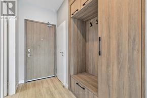 Hamilton (Central) condo for rent - A wood paneled hallway with a door and a bench.