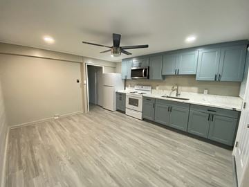Honolulu apartment for rent - A kitchen with a white oven and a ceiling fan.