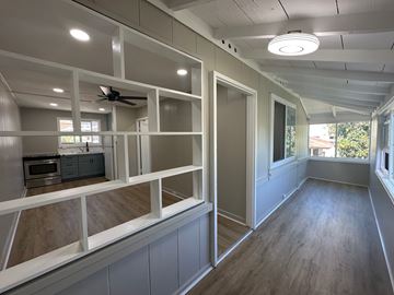 Honolulu apartment for rent - A room with a ceiling fan and a microwave.