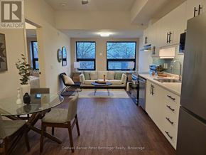 Arran-Elderslie multi-family for rent - A modern kitchen with a dining table and chairs.
