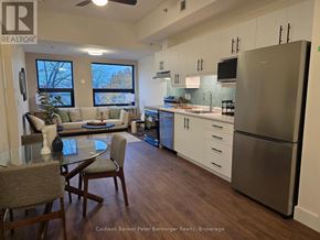Arran-Elderslie multi-family for rent - A kitchen with a refrigerator, sink, and dining table.
