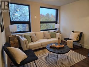 Arran-Elderslie multi-family for rent - A living room with a white couch, a black chair, and a coffee table.
