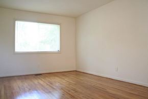 Newport News apartment for rent - an empty room with a window and wooden floors