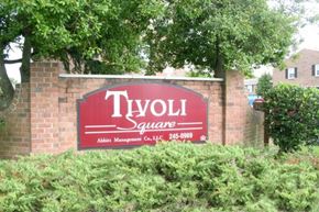 Newport News apartment for rent - a red sign sitting in front of a brick wall