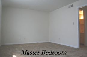 Newport News apartment for rent - an empty room with a master bedroom and a door to the bathroom
