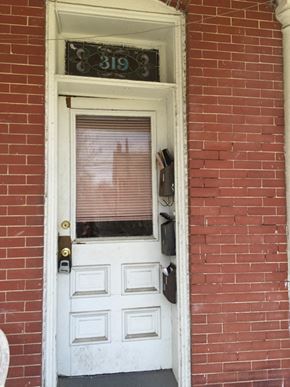 Newport News townhouse for rent - A white door with a black handle and a number 319 above it.
