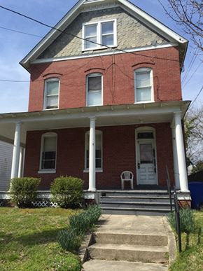 Newport News townhouse for rent - A red brick house with a white door and two windows.
