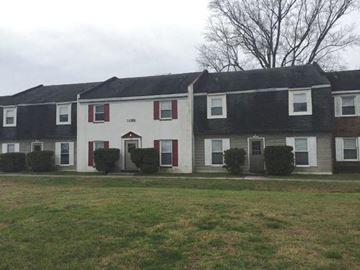 Newport News apartment for rent - a white and black house with red doors and a lawn
