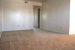 Newport News apartment for rent - an empty living room with white walls and a door