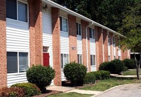 Newport News apartment for rent - a brick apartment building with a red door