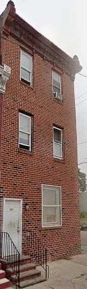 Philadelphia apartment for rent - A red brick building with a white door and windows.