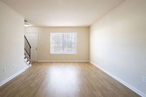 Newport News townhouse for rent - A room with a wooden floor and a staircase.