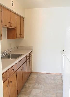 Hampton apartment for rent - a kitchen with a sink and wooden cabinets