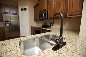 Kennesaw apartment for rent - a kitchen with a sink and a stainless steel refrigerator