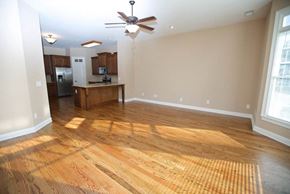 Kennesaw apartment for rent - an empty living room and kitchen with a ceiling fan