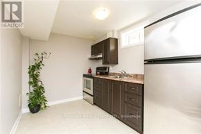 Mississauga (Churchill Meadows) house for rent - A kitchen with brown cabinets and a white countertop.