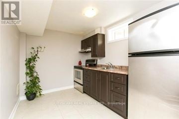 Mississauga (Churchill Meadows) house for rent - A kitchen with brown cabinets and a white countertop.