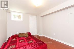 Mississauga (Churchill Meadows) house for rent - A bedroom with a red bedspread and a white door.