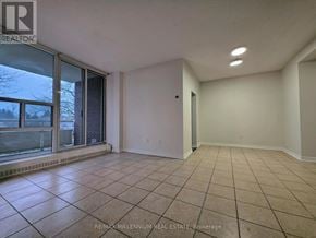 Toronto (Newtonbrook West) condo for rent - A spacious room with tiled flooring and white walls.