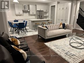 Pickering house for rent - A living room with a couch, chairs, and a dining table.