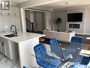 Pickering house for rent - A modern kitchen with blue chairs and a white countertop.