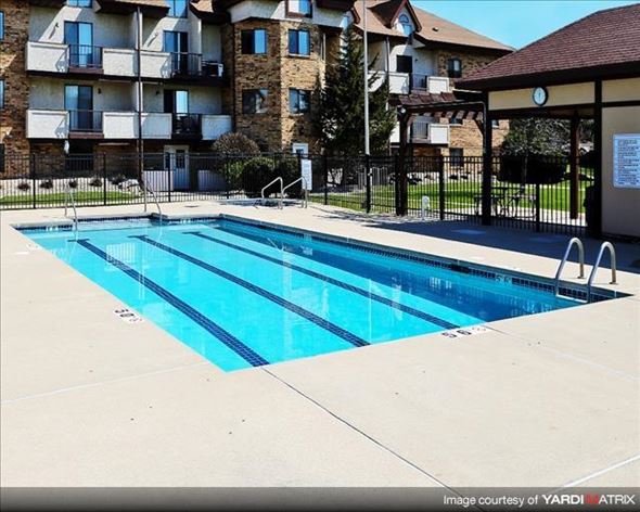 Madison apartment for rent - a swimming pool in front of an apartment building