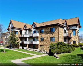 Madison apartment for rent - a large brick apartment building with a green yard