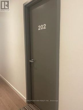Toronto (Moss Park) condo for rent - A door with the number 202 on it.